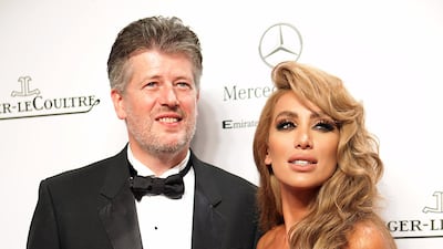 13 October 2011 - Lebanese dancer, actress and singer Maya Diab (member of The 4 Cats) arrives at the opening ceremony of the Abu Dhabi Film Festival with an unidentified guest in Abu Dhabi, United Arab Emirates. DELORES JOHNSON / The National