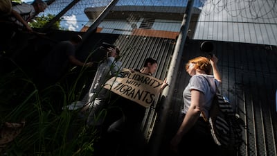 Protesters chant and hold placards against the UK deportation flights to Rwanda outside Brook House Immigration Removal Centre in June. Getty Images