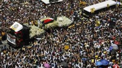 A truck carrying the casket of late former president Corazon Aquino passes thousands of people along the main street of Makati's financial business district of Manila on August 3, 2009.