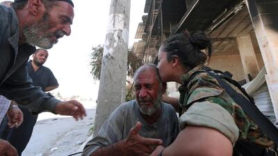 A Syria Democratic Forces (SDF) fighter comforts a civilian who was evacuated with others by the SDF from an Islamic State-controlled neighbourhood of Manbij, in Aleppo Governorate, Syria. Rodi Said / Reuters