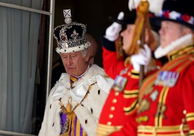 King Charles III receives a royal salute from members of the military in the gardens of Buckingham Palace. Getty Images