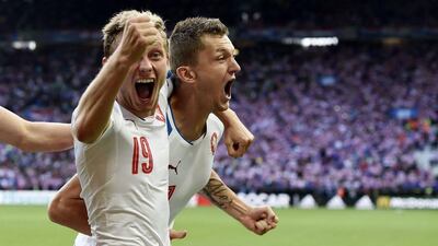 Czech Republic’s forward Tomas Necid (R) celebrates with Croatia’s midfielder Milan Badelj after scoriCzech Republic’s midfielder Ladislav Krejci during the Euro 2016 Group D football match between Czech Republic and Croatia at the Geoffroy-Guichard stadium in Saint-Etienne on June 17, 2016. Philippe Desmazes / AFP