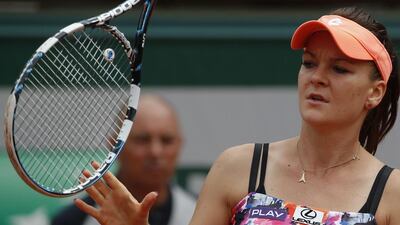Poland's Agnieszka Radwanska catches her racket as she plays Croatia's Ajla Tomljanovic during their third round match of the French Open. Tomljanovic won 6-4, 6-4. Michel Euler / AP Photo