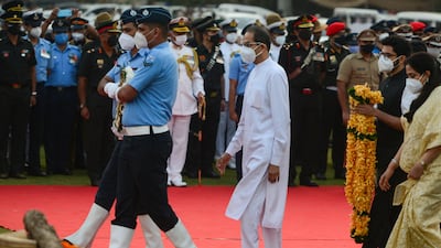 Chief Minister of Maharashtra Uddhav Thackeray, left, with his son, minister Aditya Thackeray, and wife attends the funeral ceremony of Bollywood singer Lata Mangeshkar. AFP