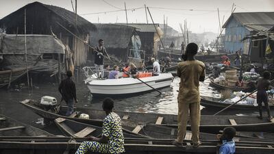 Jesco Denzel's image shows a boat with tourists from Lagos Marina, steered through the canals of the Makoko community - an ancient fishing village that has grown into an enormous informal settlement, on the shores of Lagos Lagoon, Lagos, Nigeria. He took first place in the 'Contemporary Issues - Singles' category. EPA/JESCO DENZEL