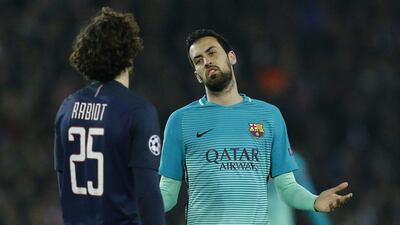 Barcelona's Sergio Busquets gestures towards Paris Saint-Germain's Adrien Rabiot. Benoit Tessier / Reuters