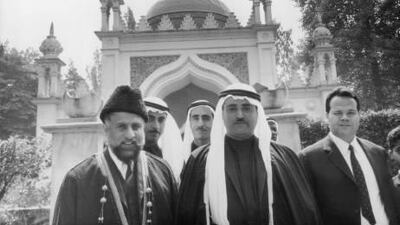 Sheikh Khalid bin Muhammad Al Qasimi, Ruler of Sharjah, with the Imam Misri, left, in front of the Shah Jehan Mosque in Woking, Surrey.