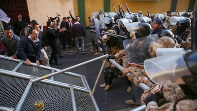 Followers of Mr Arce protest against military personnel trying to enter the government headquarters. EPA