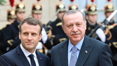 French President Emmanuel Macron, left, welcomes his Turkish counterpart Recep Tayyip Erdogan at the Elysee palace in Paris on January 5, 2018. Ludovic Marin / AFP
