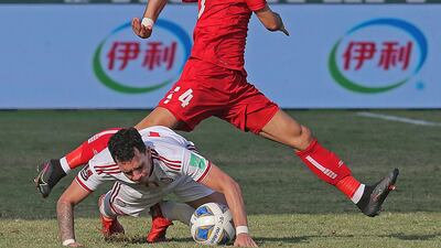 UAE forward Caio Canedo goes down under pressure from Lebanon's Abbas Assi. AFP