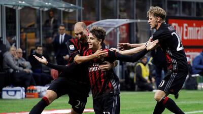 AC Milan’s Manuel Locatelli, centre, celebrates with his teammates Gabiel Paletta, left, and Ignazio Abate. Alessandro Garofalo / Reuters