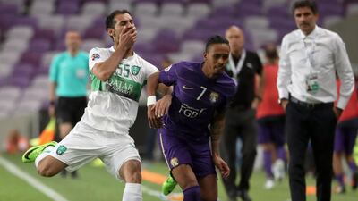 Al Ain's Lucas Fernandes Caio vies for the ball with Al Ahli's Saad Abdul-Amir during an Asian Champions League group match at the Hazza bin Zayed Stadium in Al Ain on April 11, 2017. Karim Sahib / AFP