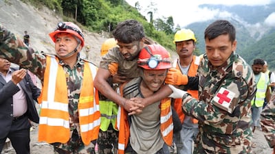 Emergency workers carry a survivor found in a tunnel at the Trishuli-3A hydropower project in Nepal. Reuters