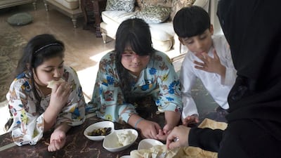 Noura Al Khoori and her children eat nabulsi and chaami cheeses at their Abu Dhabi home. Delores Johnson / The National