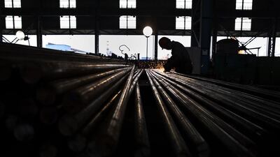A worker welds steel bars for export in the production area of the Zhong Tian (Zenith) Steel Group Corporation. Beijing has set up a fund to restructure companies. Kevin Frayer / Getty