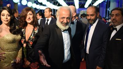 Syrian actor Ayman Zeidan, centre, arrives with the cast of the Syrian film 'Le voyage Inacheve' on November 3, 2018, for the opening of the 29th edition of the Carthage Film Festival in Tunis. AFP