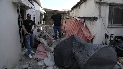 Palestinians survey the ruins of the home of Mr Kharousha, who had been accused of shooting two Israelis dead. AP
