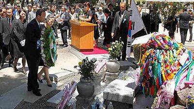 The UN secretary general Ban Ki-moon, left front, and his wife Yoo Soon-taek lay flowers at the cenotaph for Korean atomic bomb victims at Peace Memorial Park at Hiroshima today.