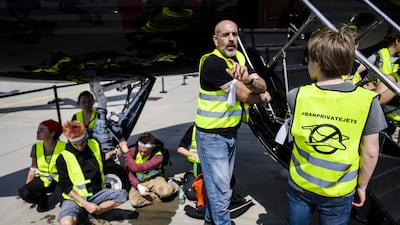 Environmental activists engage in a climate protest at the European Business Aviation Convention and Exhibition at Geneva Airport in Switzerland. EPA