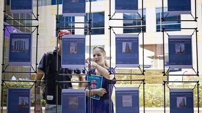 Dubai - March 30, 2010: Customers brows the selection of property ads posted at the Better Homes office in the Gold and Diamonds Souk. Lauren Lancaster /The National KEY WORDS: Real Estate Agent home homes rent rentals