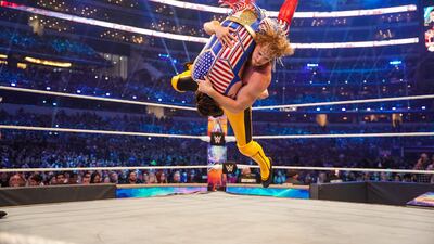 Logan Paul suplexes Dominik Mysterio during a tag team match at WrestleMania 38.