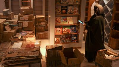 A worker arranges bookshelves ahead of the opening of the new Samir Mansour bookshop that was destroyed during last year's 11-day war between Israel and the Palestinian Hamas movement, in Gaza City.