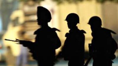 Indian Army soldiers take their positions outside the Taj Mahal Hotel in Mumbai on November 28 last year.