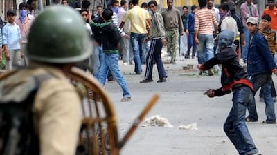 Kashmiri protesters throw stones at Indian paramilitary troops during a protest in the city of Srinagar. Rouf Bhat / AFP