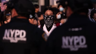 A demonstrator faces off with police officers during a protest against deportations by US Immigration and Customs Enforcement, outside New York City's federal buildings. AFP