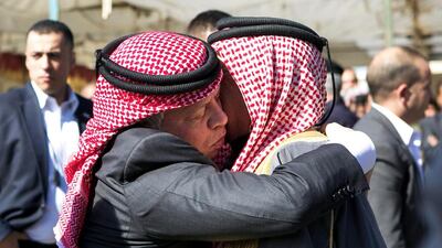 King Abdullah II of Jordan embraces Safi Al Kassasbeh, the father of executed Jordanian pilot Maaz Al Kassasbeh in Ai village yesterday. EPA