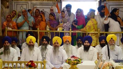 Indian Sikh devotees pay respects during a 'Jalau', a show of Sikh symbolic items, inside the Golden Temple in Amritsar. Narinder Nanu / AFP