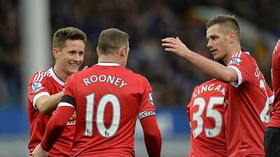 Manchester United goalscorers, from left, Ander Herrera, Wayne Rooney and Morgan Schneiderlin celebrate the third goal at Goodison Park, on October 18, 2015. Peter Powell / EPA
