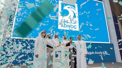 Dr Sultan Al Jaber, Minister of State and Adnoc Group and Adnoc Ambassadors celebrate the company's new structure. Antonie Robertson / The National
