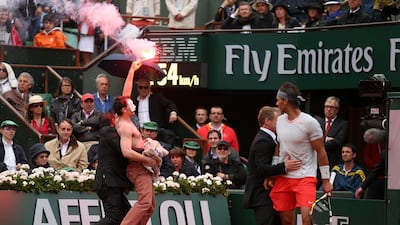 There were a few of distractions during the match at Roland Garros. One such incident included a protester making his way on to the court with a flare. He even headed towards Nadal before being caught by an official. Matthew Stockman / Getty Images