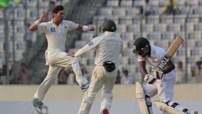 Pakistan’s Yasir Shah, left, celebrates with the dismissal of Bangladesh’s Imrul Kayes, right. A.M. Ahad / AP Photo