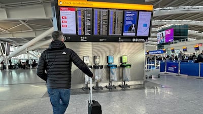 Passengers at Heathrow Airport Terminal 5 in London. About 2.8 million passengers travelled through the UK hub last month, 15 per cent below its forecast. PA