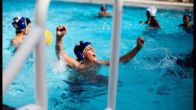 A boy cheers after deflecting a goal while playing water-polo at the Ruwais Recreation Center. Razan Alzayani / The National