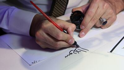 A calligraphy artist practises his Arabic