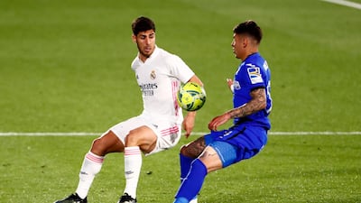 Real Madrid's Marco Asensio up against Getafe's Mathias Olivera. Reuters