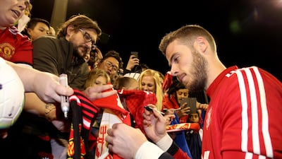Manchester United goalkeeper David De Gea signs autographs after a training session at the WACA in Perth. EPA