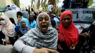 A Sudanese woman chants slogans outside the court during the new trial against ousted President Omar al-Bashir and some of his former allies on charges of leading a military coup that brought the autocrat to power in 1989 in Khartoum, Sudan. REUTERS