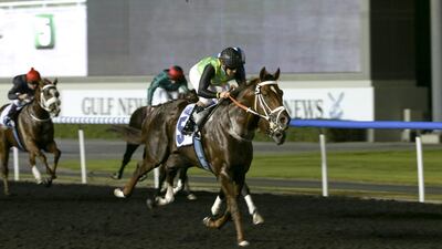 Variety Club, with Anton Marcus aboard, races to the finish line for the Firebreak Stakes at Meydan Racecourse. Razan Alzayani / The National
