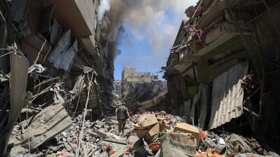 A Palestinian man inspects the site of Israeli strikes on buildings at Gaza's Old City market. Reuters