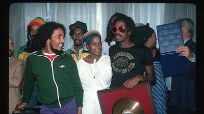 Bob Marley and Bunny Wailer receive a gold record for sales with their band the Wailers. Getty Images