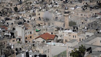 Smoke above a Nablus neighbourhood as Palestinians clash with Israeli forces. AP