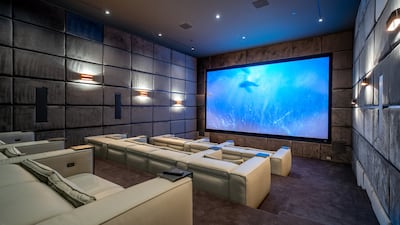 An elegant home theatre with motorised seating.