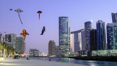 People connect with the coastline on Reem Island in Abu Dhabi. Victor Besa / The National