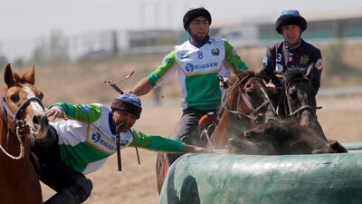 Uzbek and French horsemen take part in kok-boru. EPA