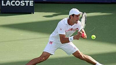 Novak Djokovic struggles to get to the ball in his second round match against Viktor Troicki at the Dubai Tennis Championships yesterday.