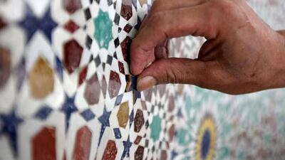 Qasim Thaesh, a craftsman that has been flown in from Morocco, fills in a star on the mosaic in the Mehrab area at the under construction Al Farooq mosque in Al Safa area in Dubai.